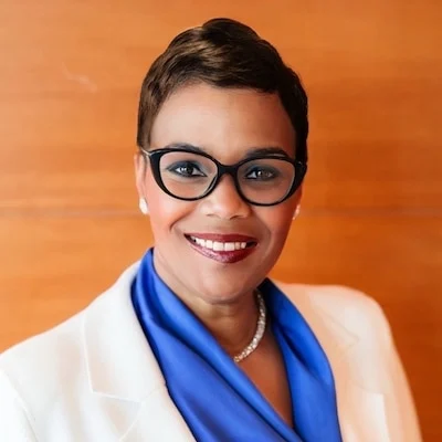 Smiling professional woman wearing glasses and blazer