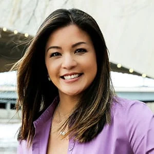 Smiling woman in purple shirt outdoors