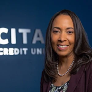 Smiling woman at credit union office background