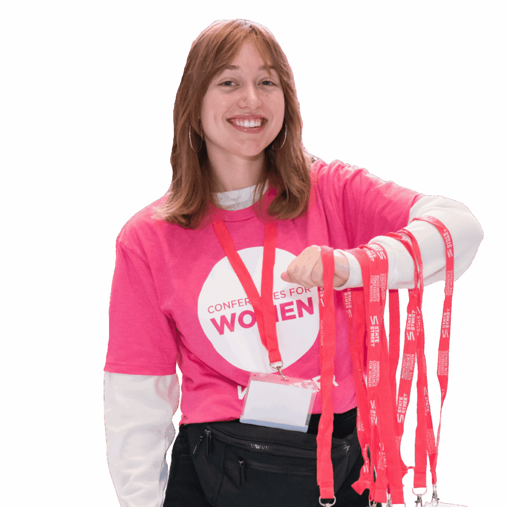 Smiling volunteer with lanyards, Conferences for Women shirt.