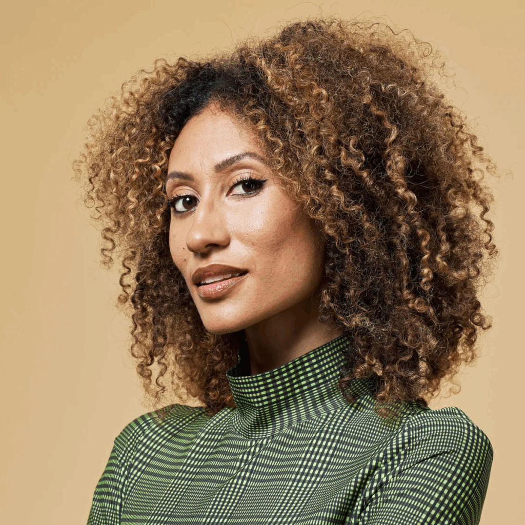 Woman with curly hair in green patterned top