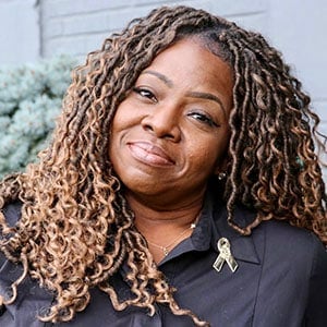 Smiling woman with long curly hair outdoors