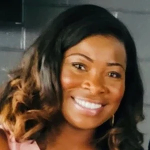 Smiling woman with wavy brown hair indoors