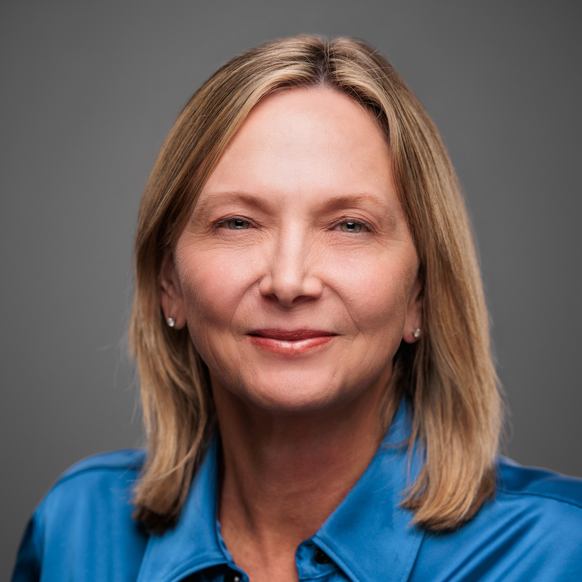 Smiling woman in blue shirt portrait