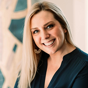 Smiling woman with long blonde hair indoors