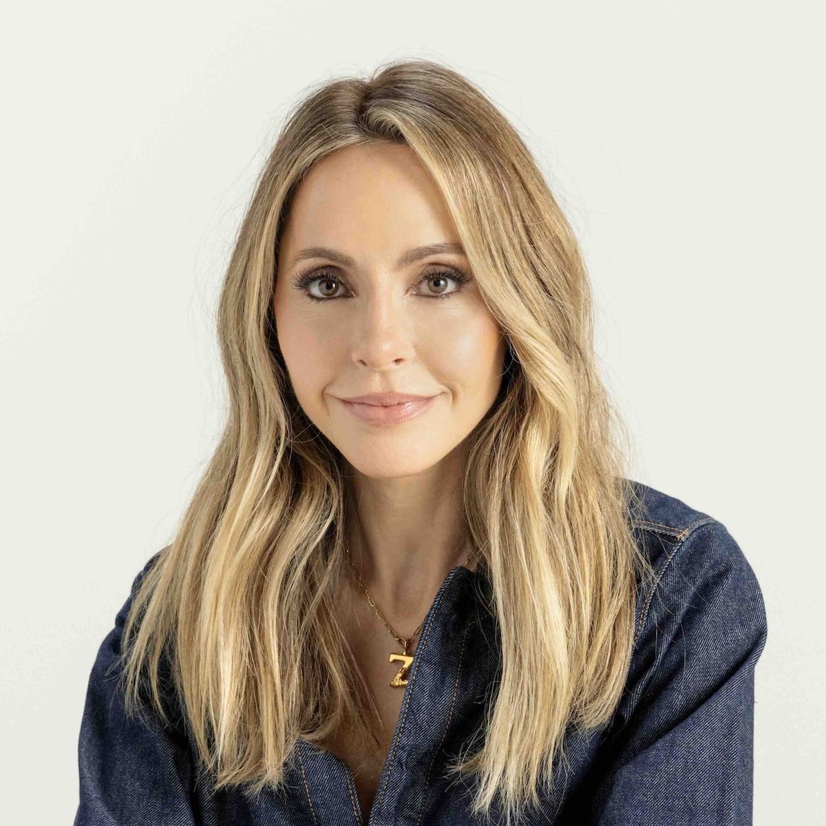 Woman with long blonde hair wearing denim shirt