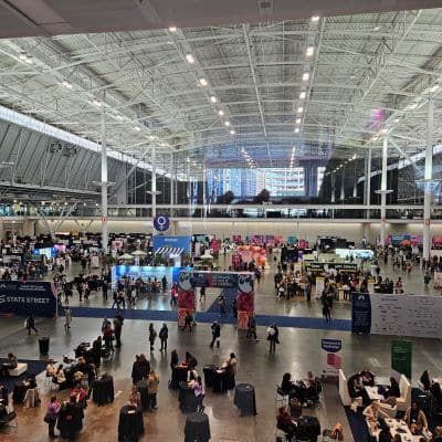 Large convention center with people and exhibition booths