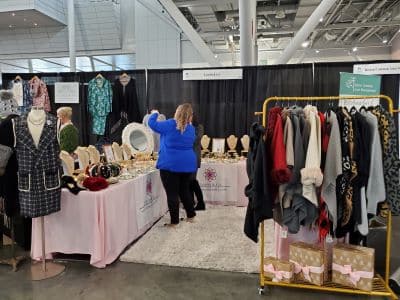Women shopping at boutique clothing and jewelry booth