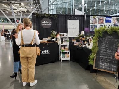 People chatting at oHHo product booth display