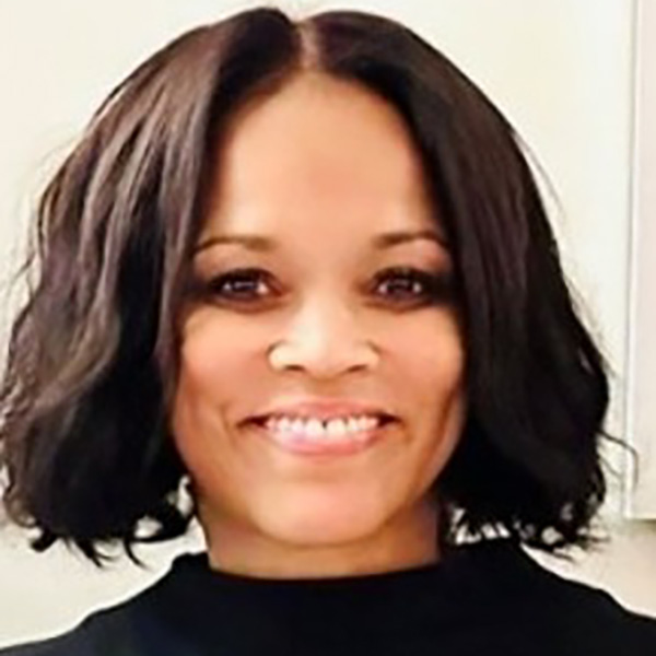 Smiling woman with short dark hair indoors