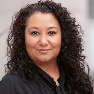 Smiling woman with curly hair in black top
