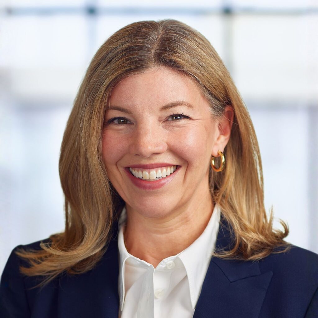 Smiling professional woman in navy blazer headshot