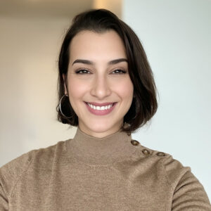 Smiling woman wearing brown sweater indoors