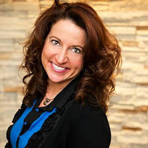 Smiling woman with curly brown hair indoors