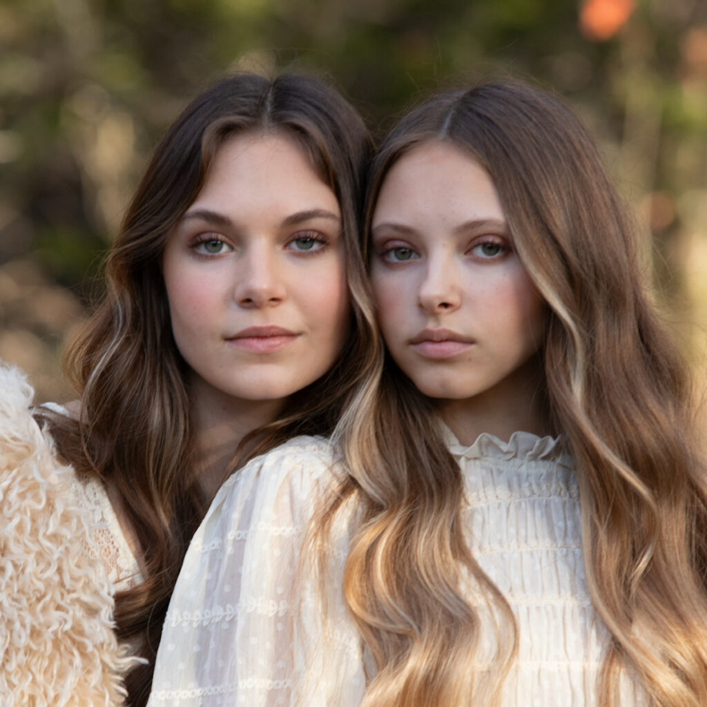 Two women with long hair outdoors