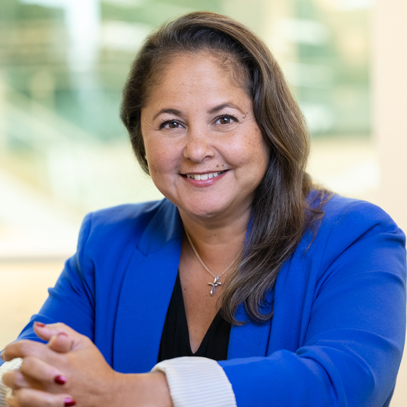 Smiling woman in blue blazer at office
