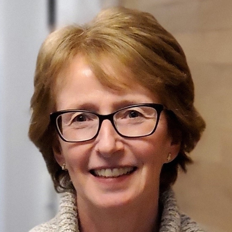 Smiling woman wearing glasses indoors