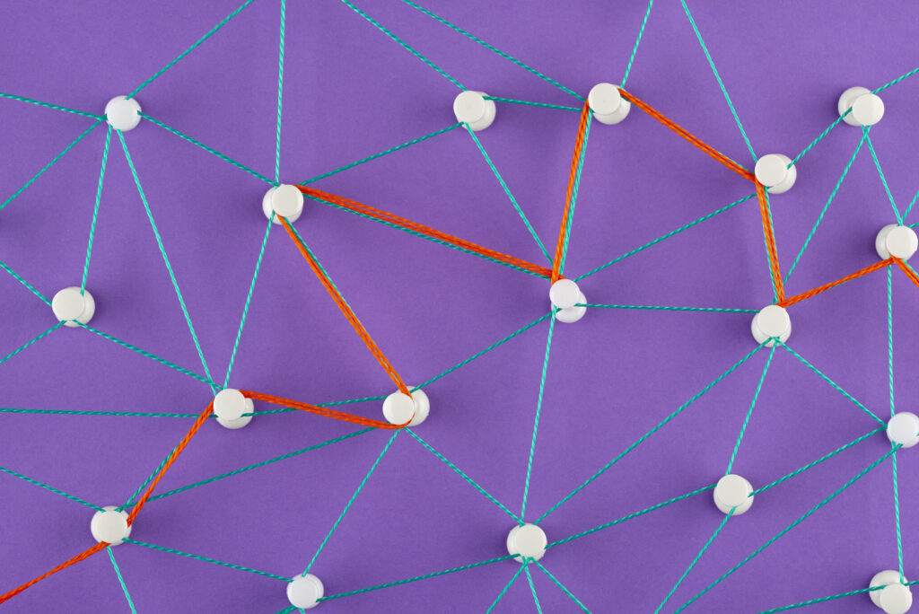 Network connections made with colorful strings on purple background