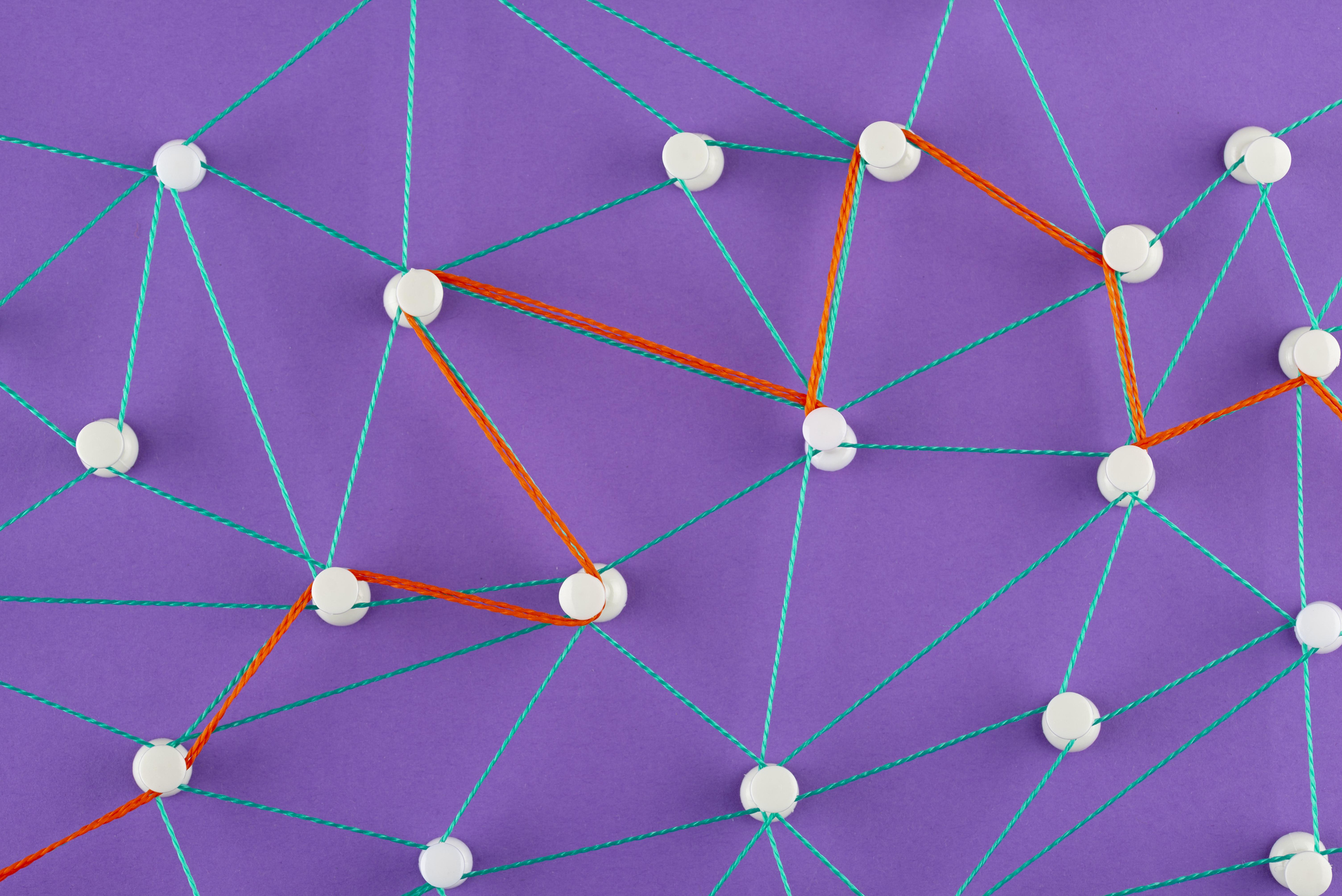 Network connections made with colorful strings on purple background