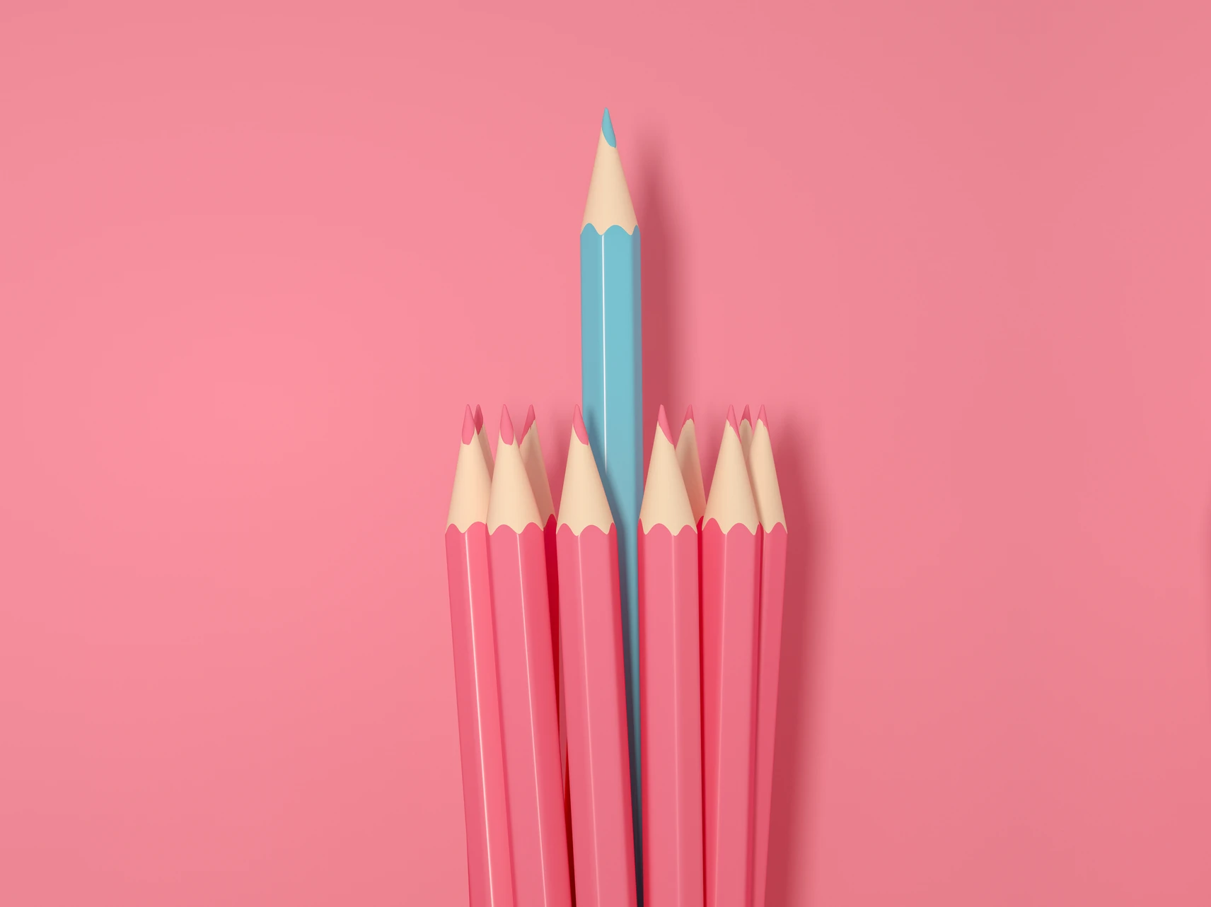 pink colored pencils on pink background with blue colored pencil in the middle
