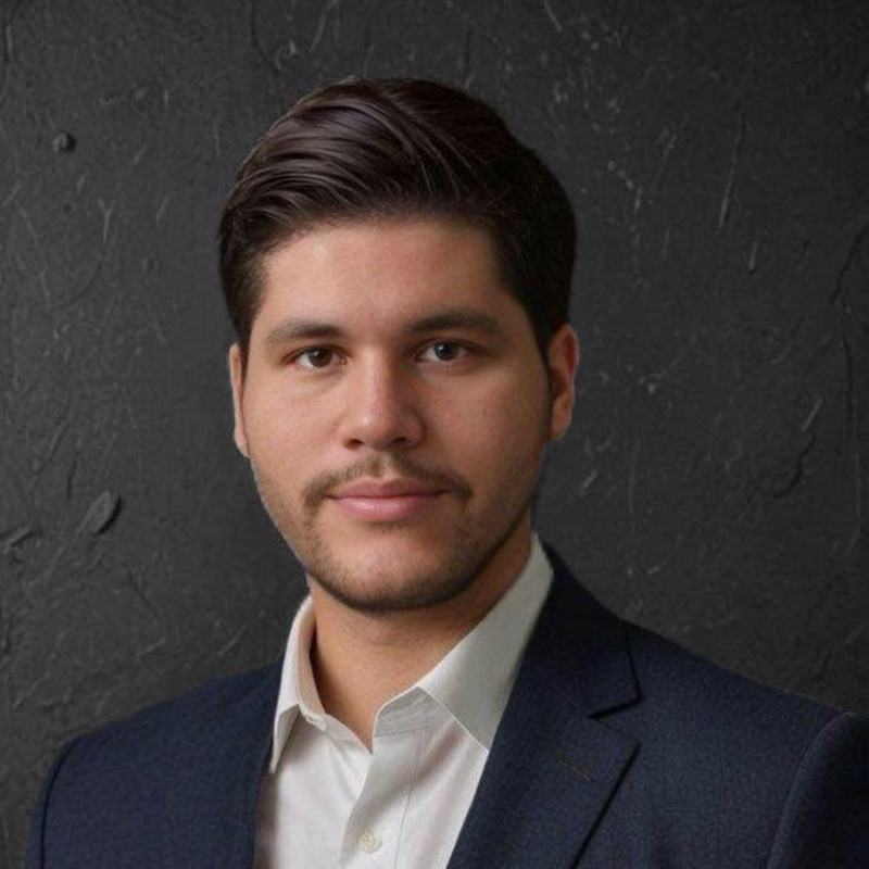 Man in suit posing against dark background