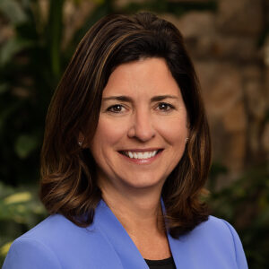 Smiling woman in blue blazer outdoors