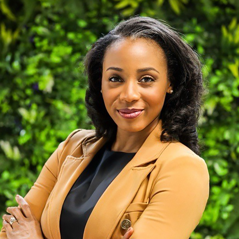 Confident woman smiling outdoors in professional attire