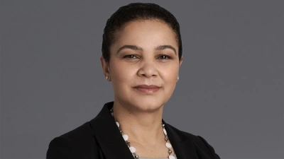 Professional woman wearing blazer and necklace smiling