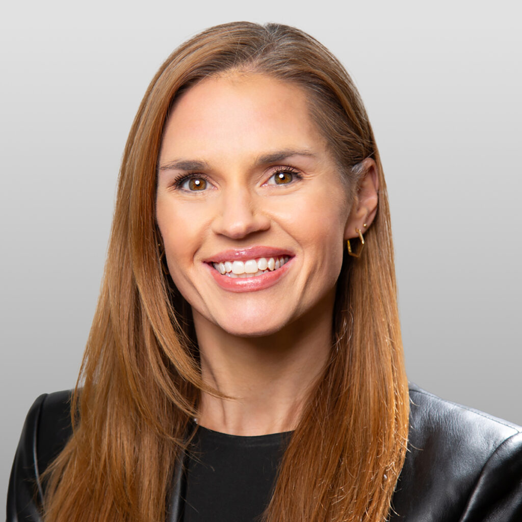 Smiling woman with straight brown hair in black outfit