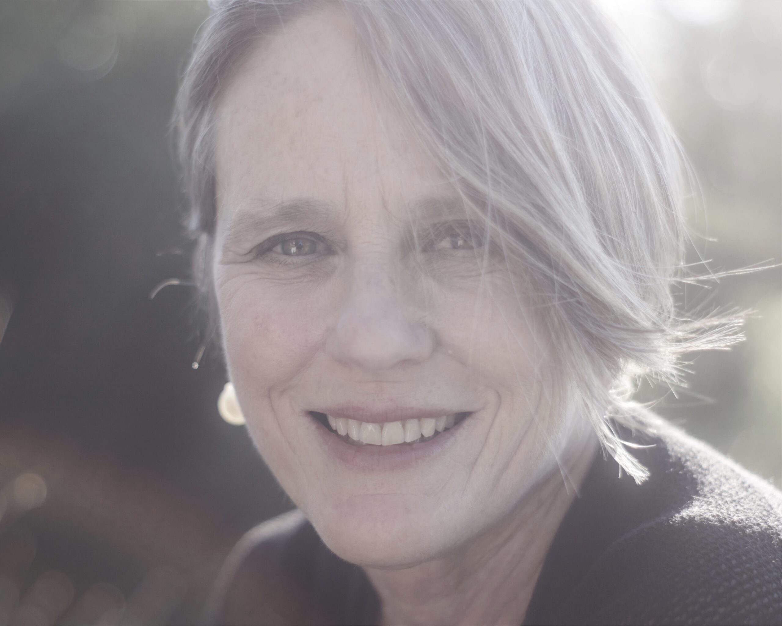Close-up of smiling older woman in soft light