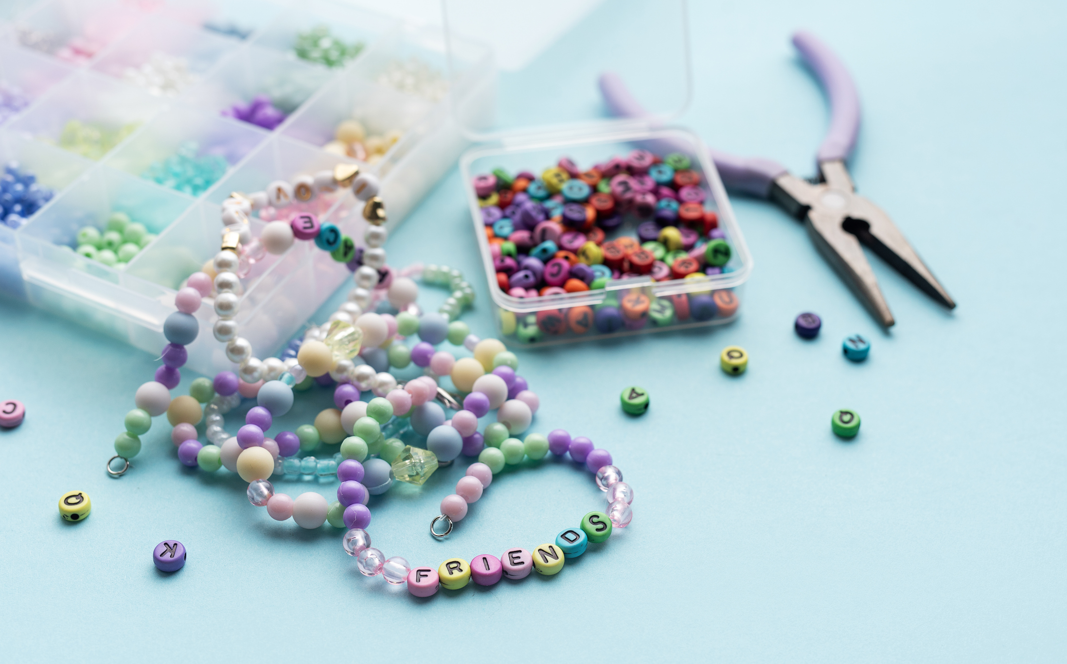 Colorful handmade beaded friendship bracelets with craft supplies