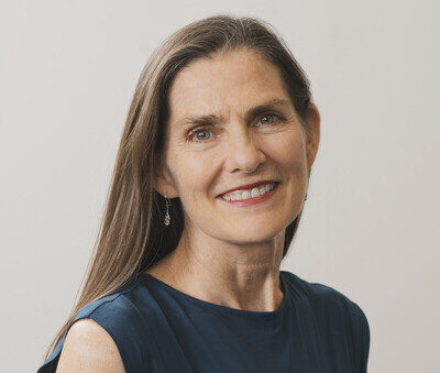 Smiling woman in a navy sleeveless top
