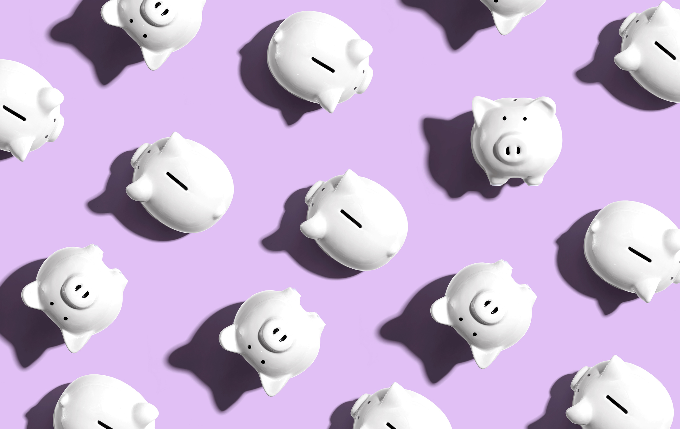 White piggy banks on a lavender background